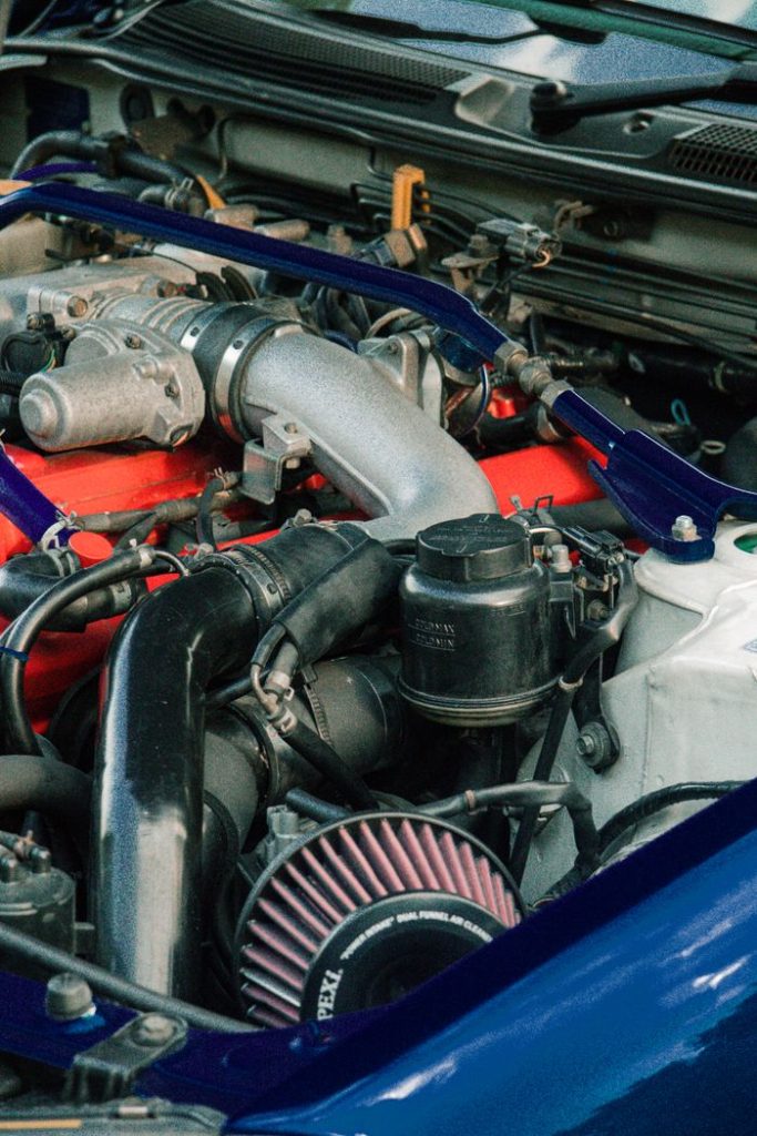 Detailed view of car engine components with focus on parts and machinery.