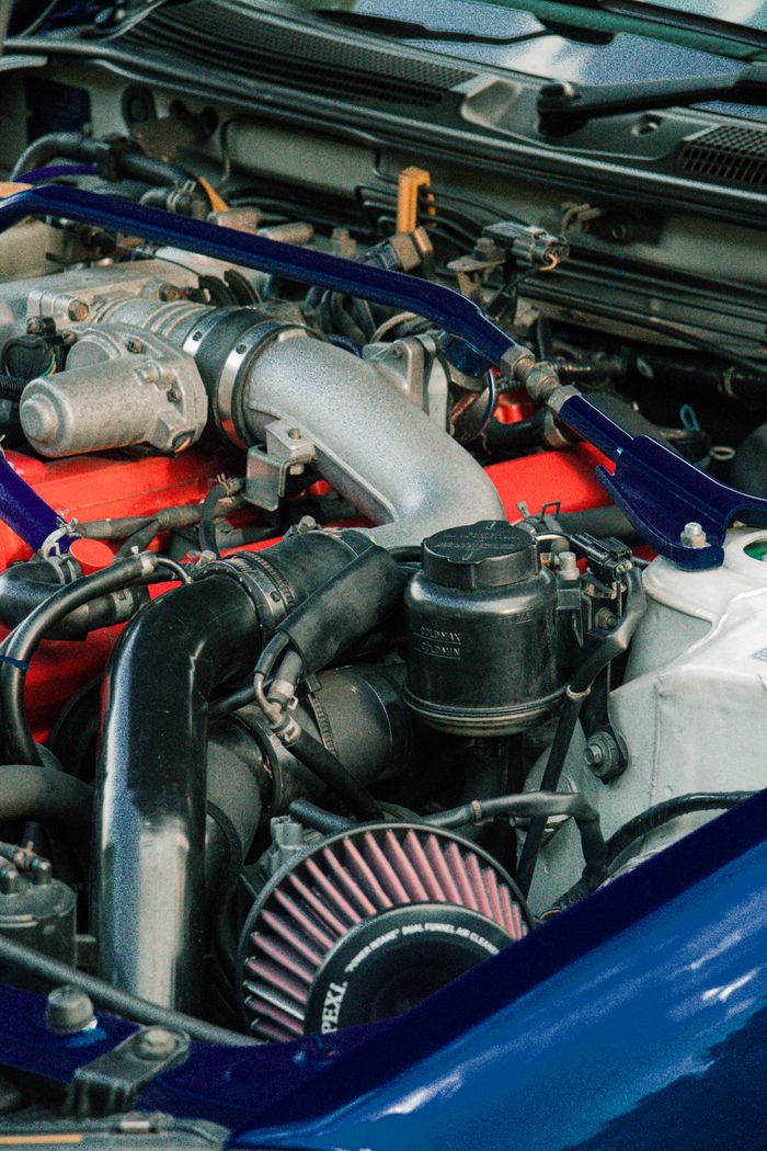 Detailed view of car engine components with focus on parts and machinery.