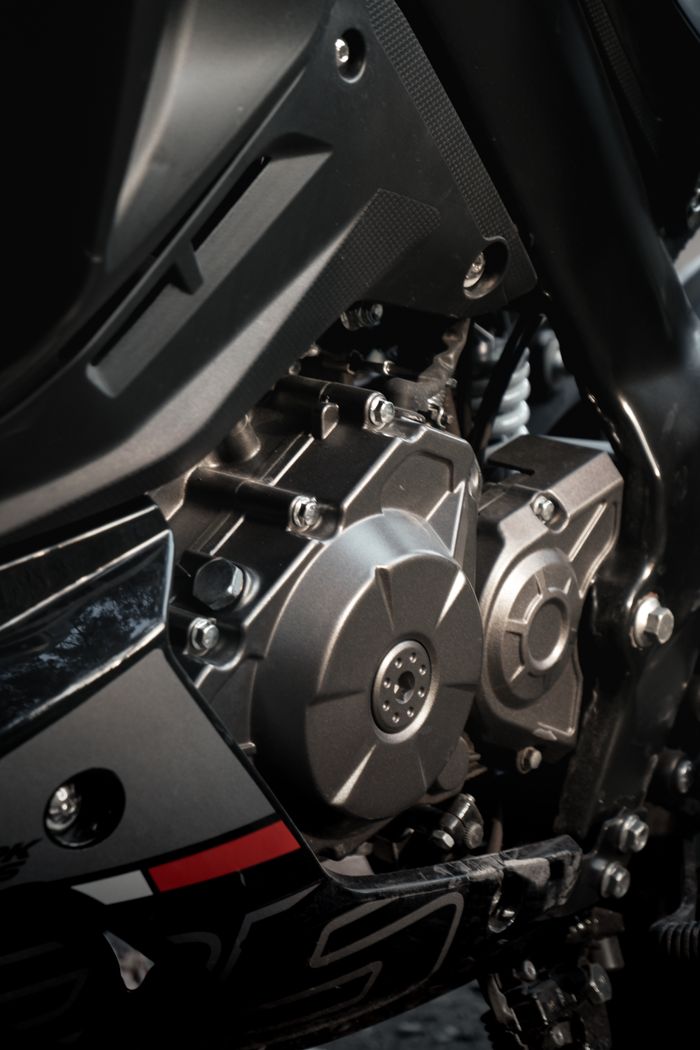 our-story-02 Detailed view of a motorcycle engine showcasing mechanical precision and design.