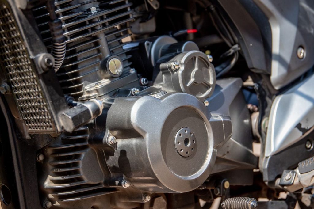 Detailed shot of a motorcycle engine showcasing intricate parts and craftsmanship.